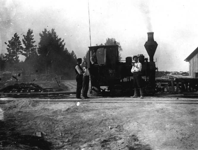 Steam locomotive with workers
