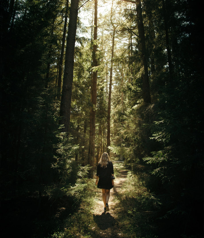 A woman walking through forest